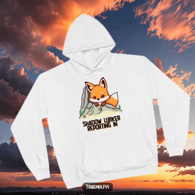 Funny fox peeking from behind a mountain, cozy hoodie design, celebrating nature's wonder and a playful spirit.