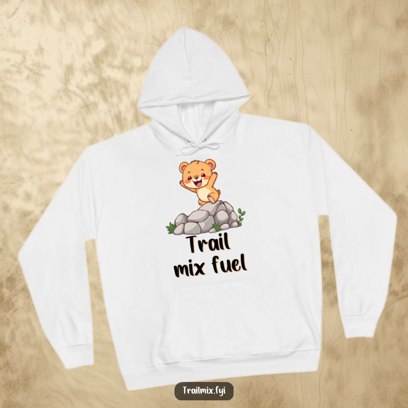 Funny bear cub hoodie featuring a cheerful character enthusiastically climbing a rugged, rocky trail, perfect for outdoor enthusiasts.