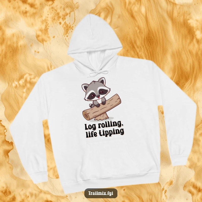 Funny hoodie showing a playful cartoon raccoon comically balancing on a log, perfect for cozy, humorous moments.