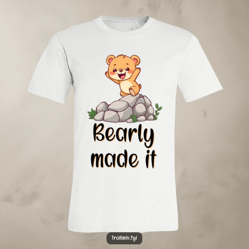 Funny bear cub t-shirt with a cheerful character enthusiastically climbing a rocky mountain trail, symbolizing determination and joy.